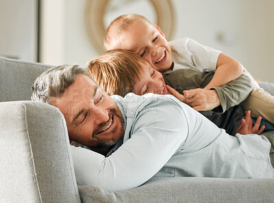 Buy stock photo Father, kids and relax in pile in home, peace and single parent love for boys in living room. Daddy, children and stack for resting on couch for care in childhood, relationship and comfortable joy