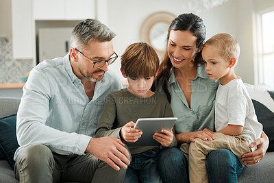 Buy stock photo Home, family and parents with tablet, kids and typing for social media, entertainment and connection. Apartment, mother and father with children, tech and digital app for game and online reading