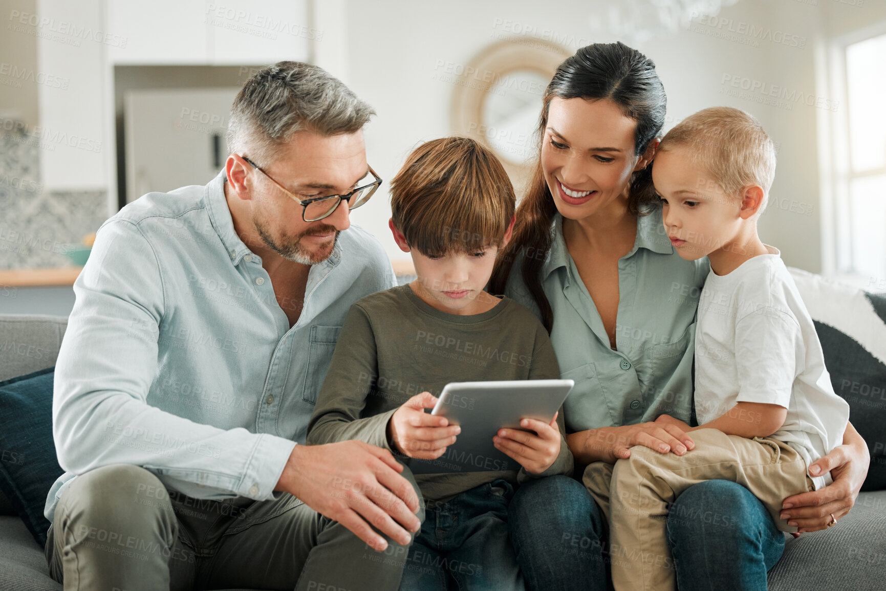 Buy stock photo Home, family and parents with tablet, kids and typing for social media, entertainment and connection. Apartment, mother and father with children, tech and digital app for game and online reading