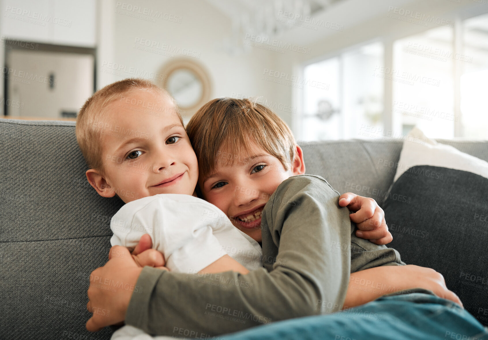 Buy stock photo Portrait, smile and children with hug on sofa for sibling bonding, care and support of connection in living room. Happy, family and boy with embrace for trust, security and relax on couch at house