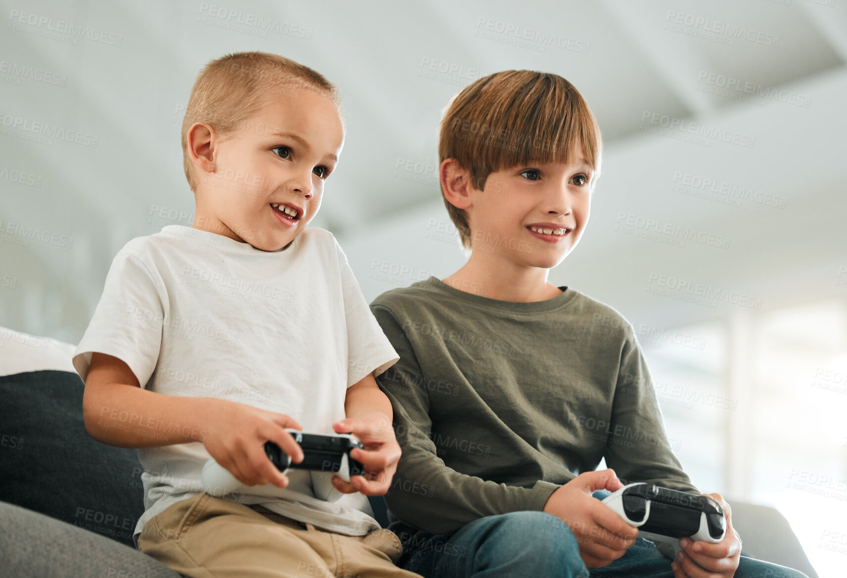 Buy stock photo Brothers, children and home with console controller for gaming or online challenge, together with support for play. Child champion, esports or multiplayer experience on sofa for development with tech