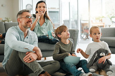 Buy stock photo Parents, kids and happy for watching tv in home with popcorns for movies, film and series. Family, people and smile for bonding with streaming platform or subscription for entertainment in lounge