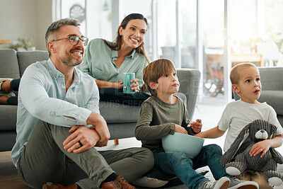 Buy stock photo Parents, kids and smile for watching tv in home with popcorns for movies, film and series. Family, people and happy for bonding with streaming platform or subscription for entertainment in lounge