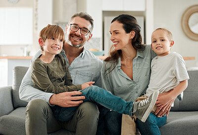 Buy stock photo Family portrait, kids and hug in home for trust, peace and connection for bonding on sofa. Parents, children and embrace for security on couch for care in childhood, relationship and comfortable