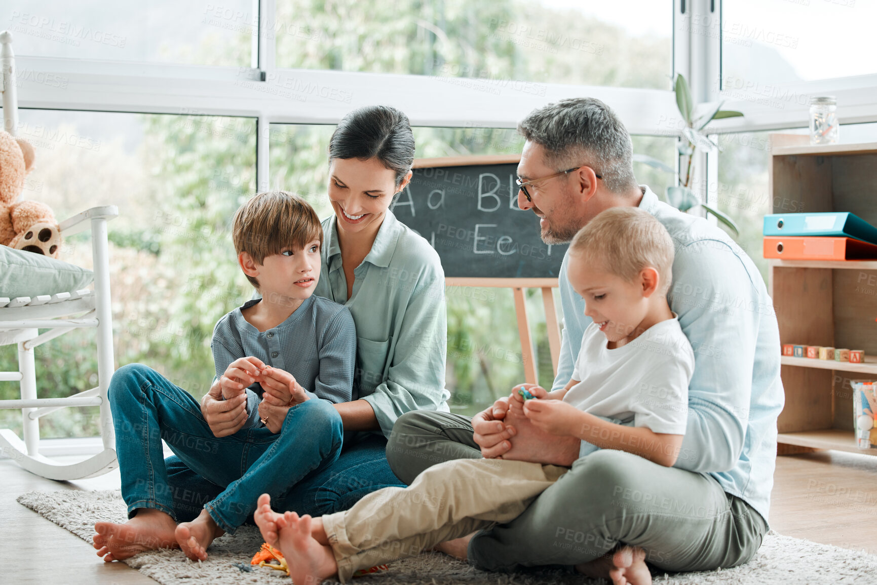 Buy stock photo Parents, kids and happy family play with toys for learning, education and bonding together. Smile, mother and father with children on floor for love, support and care for brothers in home living room