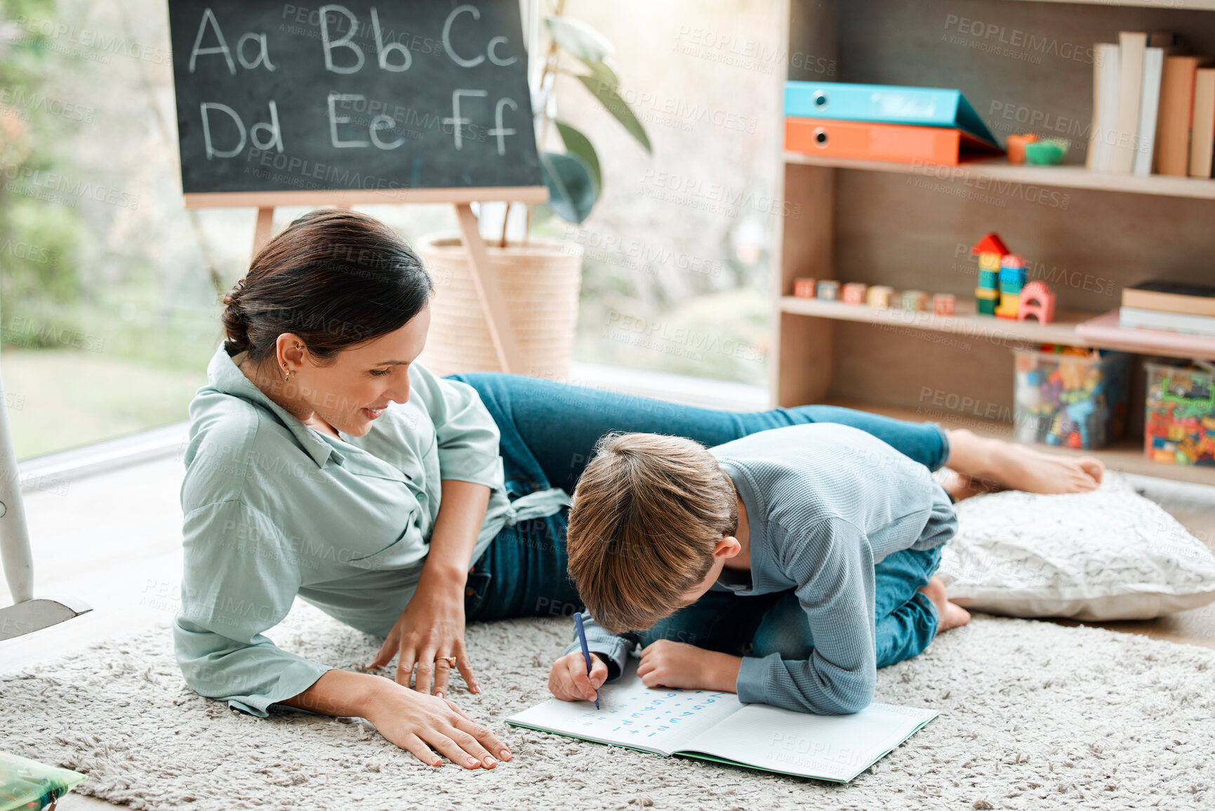 Buy stock photo Woman, child and writing in book on floor with math activity, education and bonding for learning addition of study. Mother, boy and drawing answer for assessment, homework and development at house