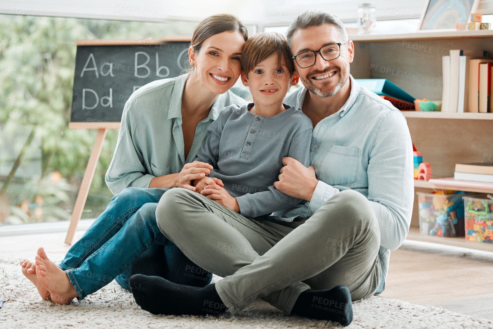 Buy stock photo Parents, child and portrait of happy family in house for learning, education and bonding together. Smile, mother and father with kid on floor to relax for love, support and care for boy in homeschool