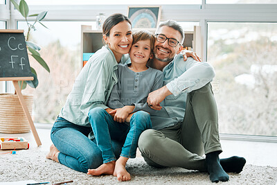 Buy stock photo Shot of two parents playing with their son at home