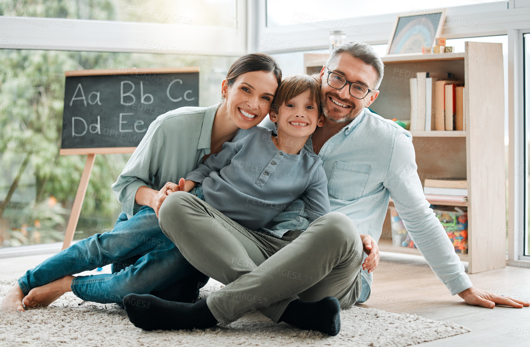 Buy stock photo Parents, child and portrait of happy family on floor for learning, education and bonding together. Smile, mother and father with kid in house to relax for love, support and care for boy in homeschool