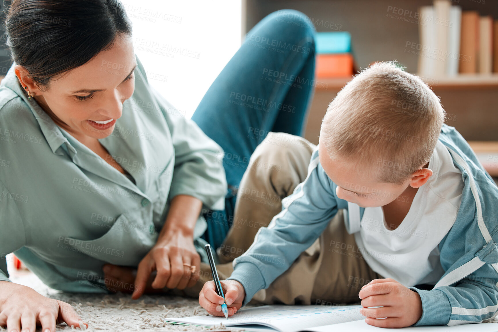 Buy stock photo Mother, child and writing in book on floor with maths activity, education and bonding for learning addition of study. Woman, boy and numbe solution for assessment, homework and development at house