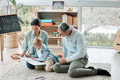 Buy stock photo Shot of two parents playing with their son at home