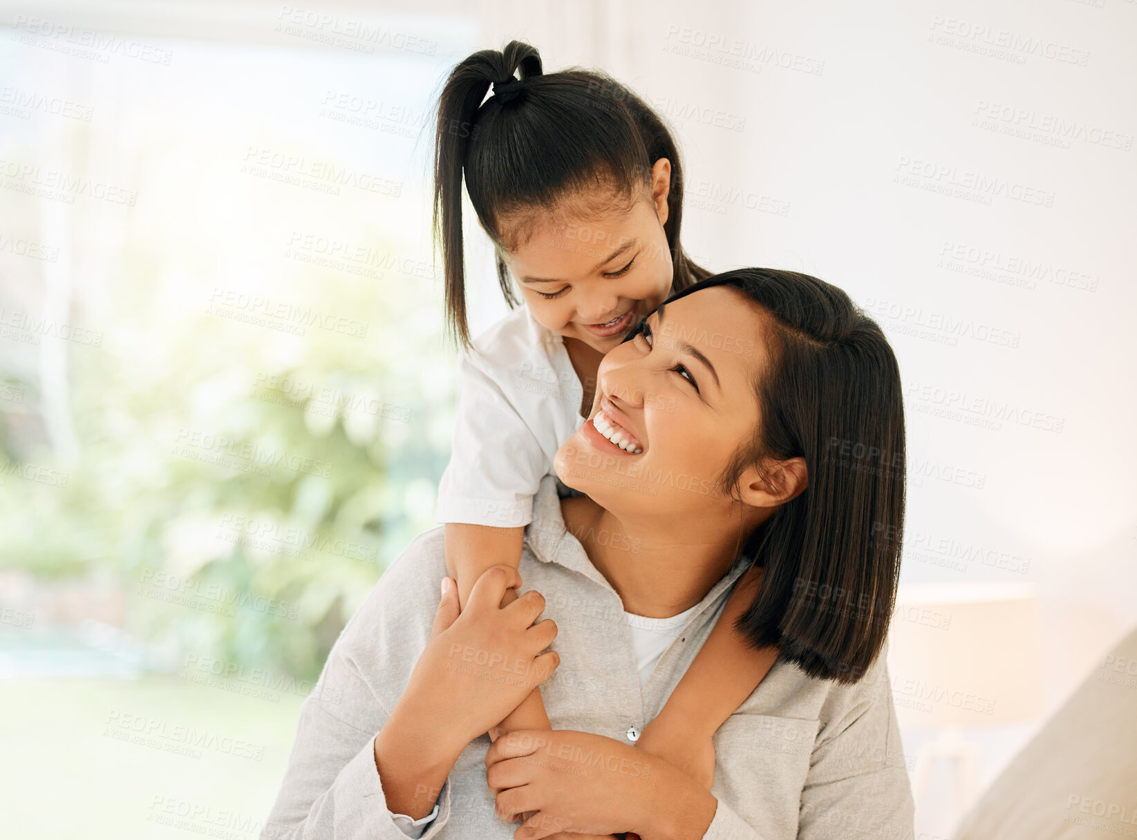 Buy stock photo Shot of a young mother and daughter bonding together at home