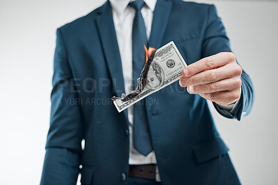 Buy stock photo Hand, man and burning money in studio on white background for economy or dollar collapse. Business person, flame and banknotes with fire for financial crisis, bankruptcy and inflation increase