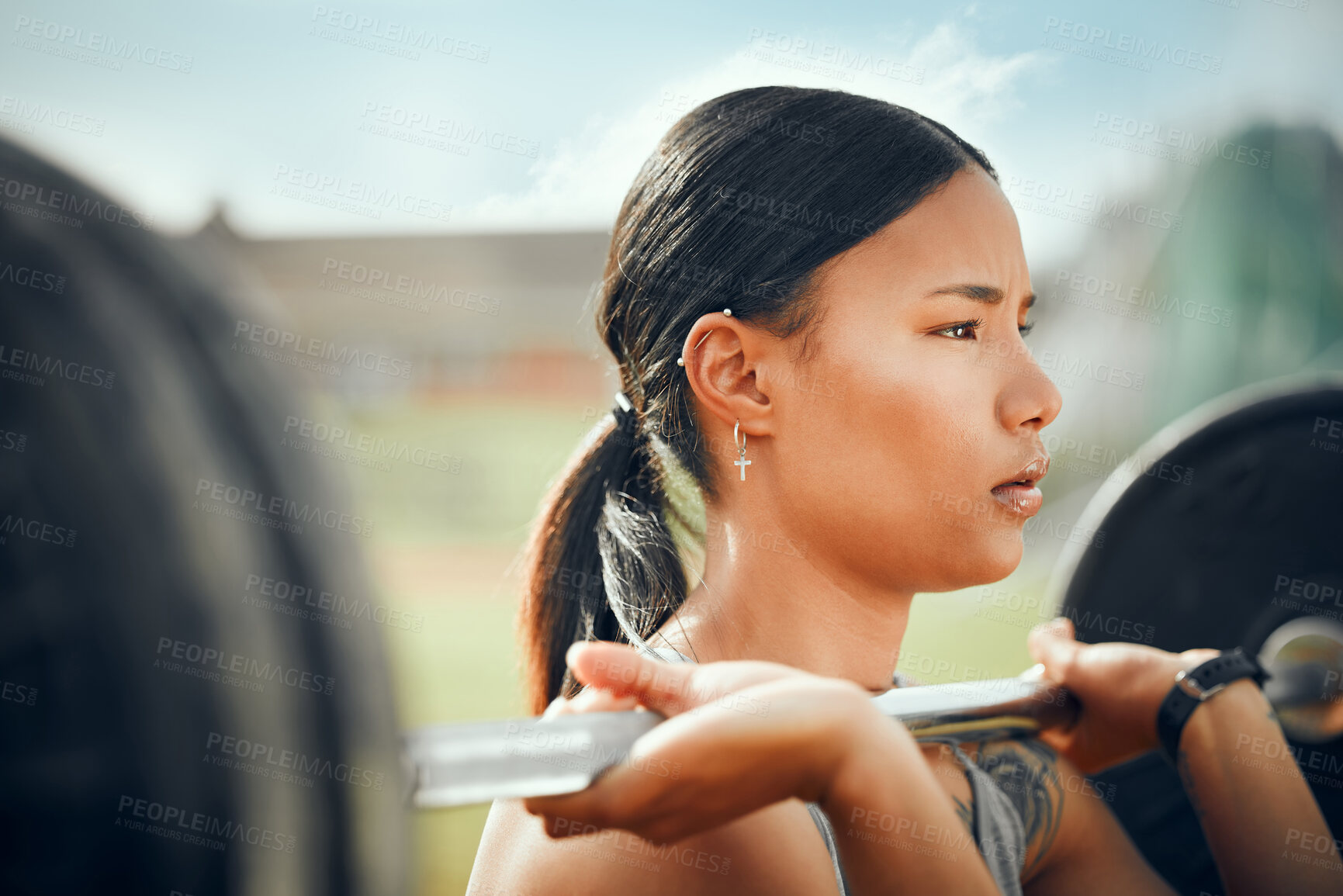 Buy stock photo Cropped shot of an attractive young female athlete exercising with weights outdoors