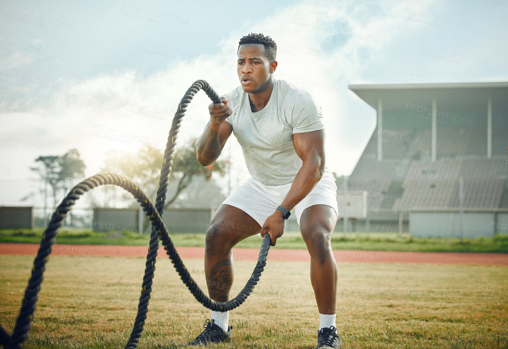 Buy stock photo Black man, outdoor and gym with battle ropes, field and fitness for resistance training or exercise. Male person, cardio and routine for bodybuilding, strong muscle and endurance for power or workout