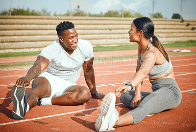 Buy stock photo Full length shot of a young athletic couple warming up before starting their outdoor exercise routine