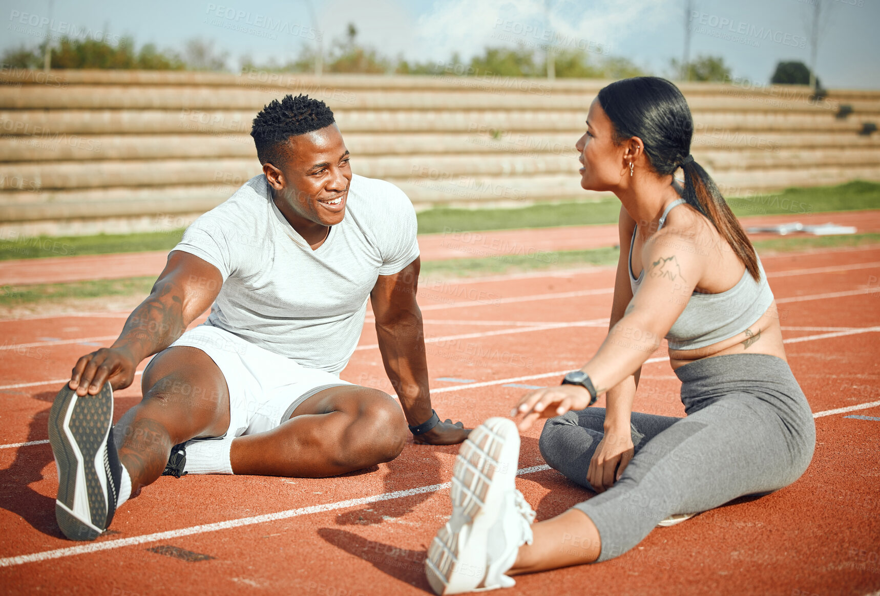 Buy stock photo Couple, talking and stretching for fitness, workout and running on track or arena together. Athlete, personal trainer and team for cardio, exercise and outdoor with wellness and commitment for sports