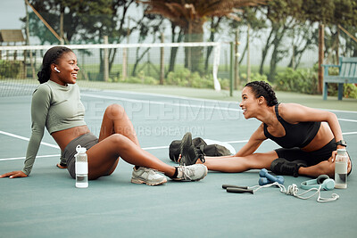 Buy stock photo Full length shot of two attractive young female athletes warming up outside before beginning their workout