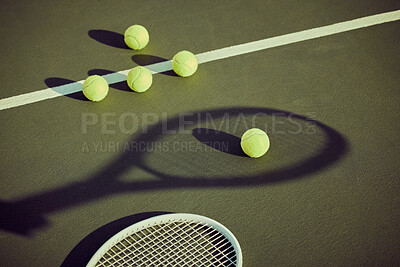 Buy stock photo Shot of tennis balls and a racket lying on a court