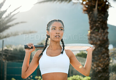 Buy stock photo Shot of a sporty young woman playing tennis on a court