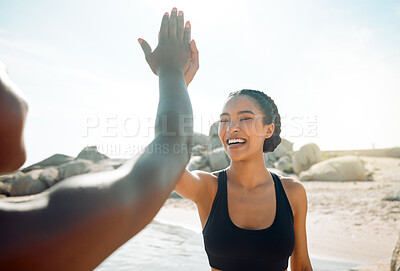 Buy stock photo Shot of two friends high fiving after a workout