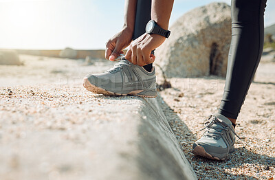 Buy stock photo Shot of a woman tying her shoe laces before a jog