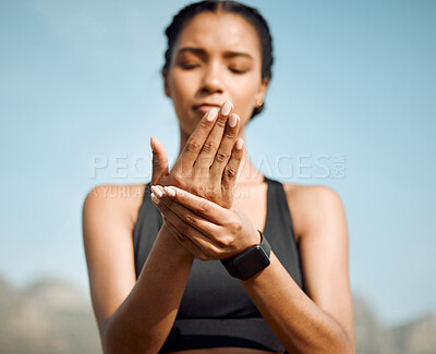 Buy stock photo Shot of a young woman massaging a cramp in her hand
