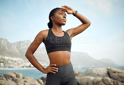 Buy stock photo Shot of a young woman taking a break from her jog