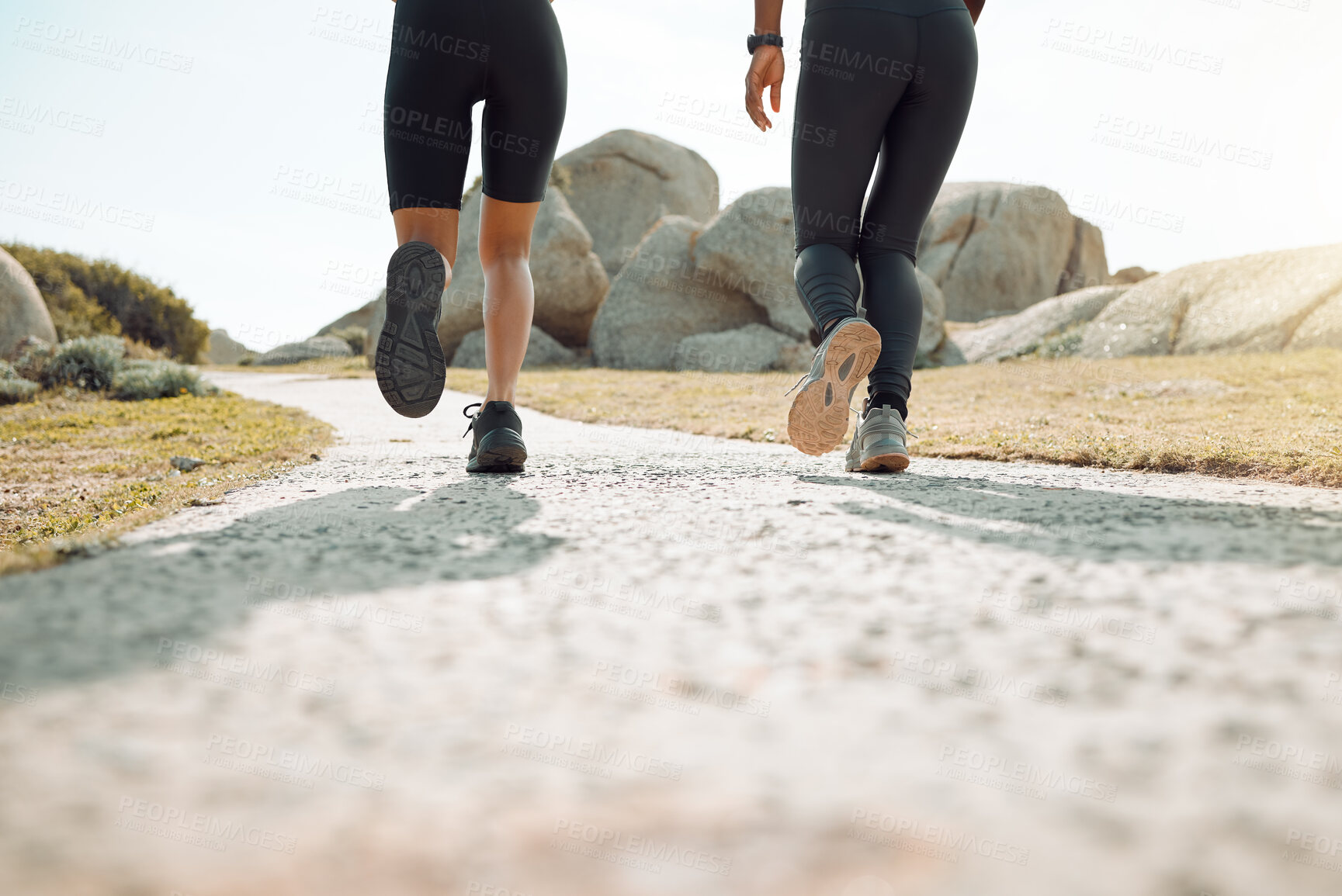 Buy stock photo Shot of two women jogging together