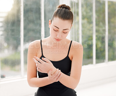 Buy stock photo Shot of a ballet dancer experiencing wrist pain during her dance routine