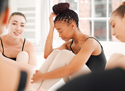 Buy stock photo Shot of a group of ballet dancers sitting together looking stressed