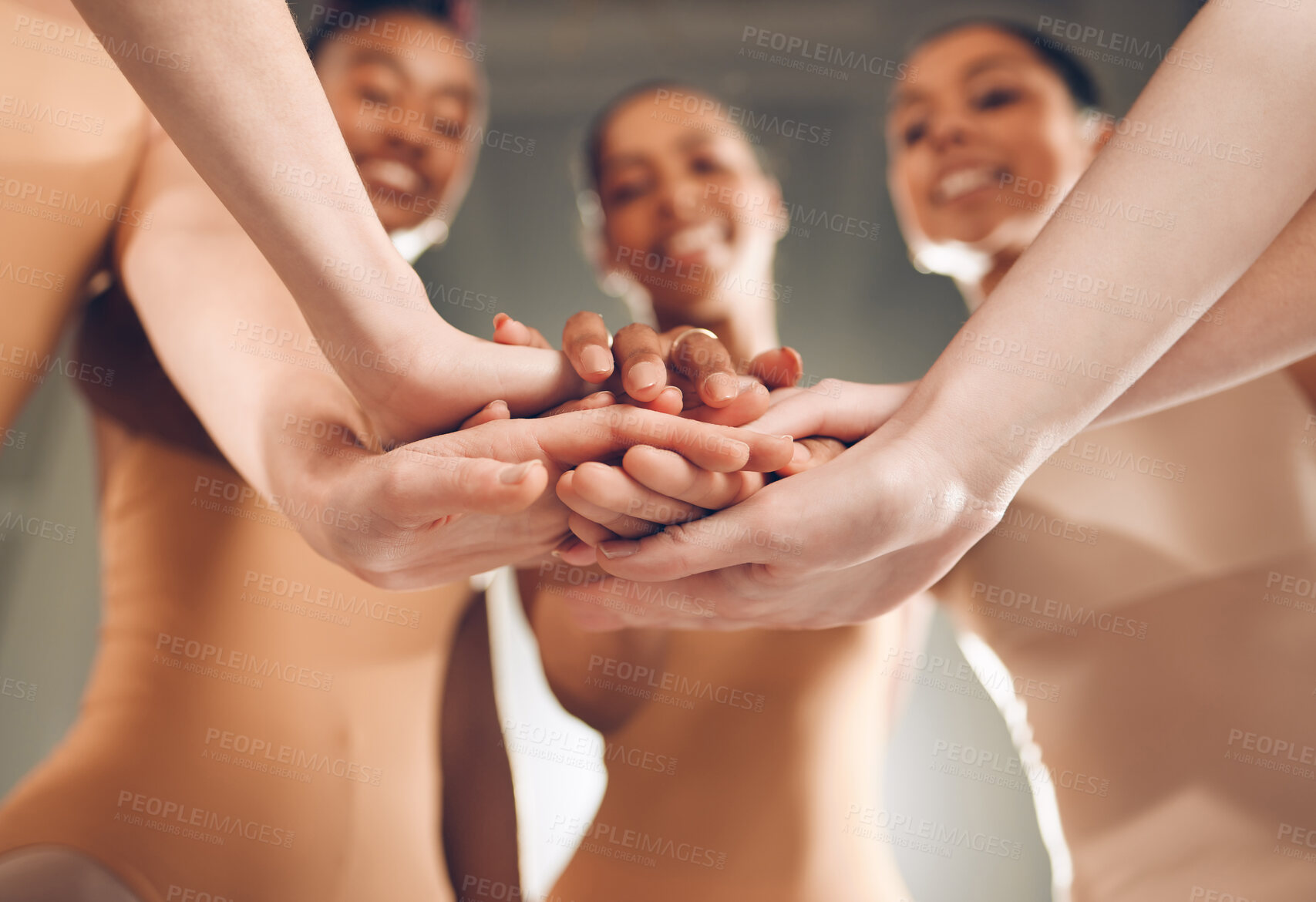 Buy stock photo Shot of a group of young ballerinas with their hands stacked