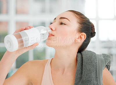 Buy stock photo Shot of a young woman drinking water while working out