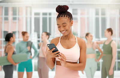 Buy stock photo Shot of a young woman checking her cellphone while at a fitness glass