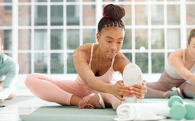Buy stock photo Shot of a beautiful young woman stretching during her workout