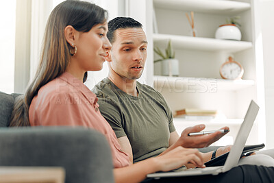 Buy stock photo Shot of two young people working at home