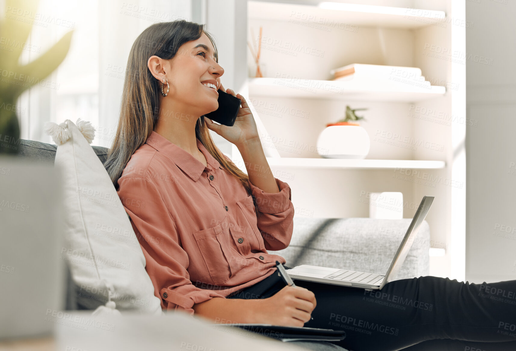 Buy stock photo Laptop, phone call and writing with freelance woman on sofa in living room of home for communication. Computer, smile and thinking with happy person talking on mobile in apartment for remote work