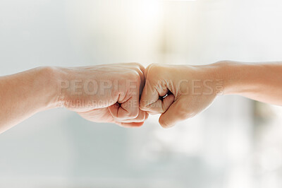 Buy stock photo Shot of two unrecognizable people fist bumping at home