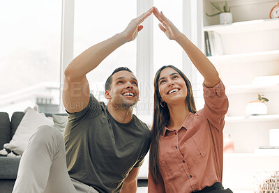 Buy stock photo Shot of a couple making a house gesture at home