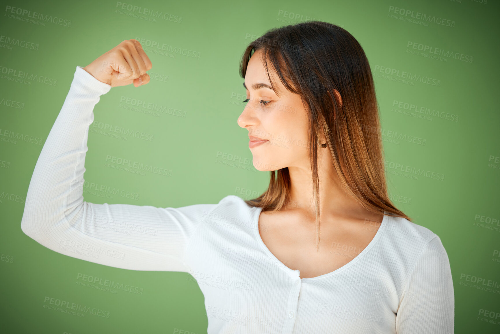 Buy stock photo Woman, smile or flex in studio for confidence, empowerment or strength. Female person, bicep or pride on green background for feminism, equality or showing muscle with happy for challenge or progress