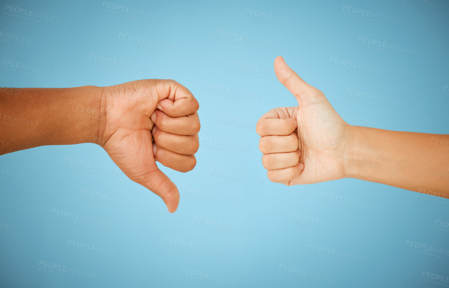 Buy stock photo Thumbs up, people or down hand gesture with for disagreement, approval and feedback on blue background. Positive, negative and icon closeup with okay sign, dislike and conflict in studio for vote