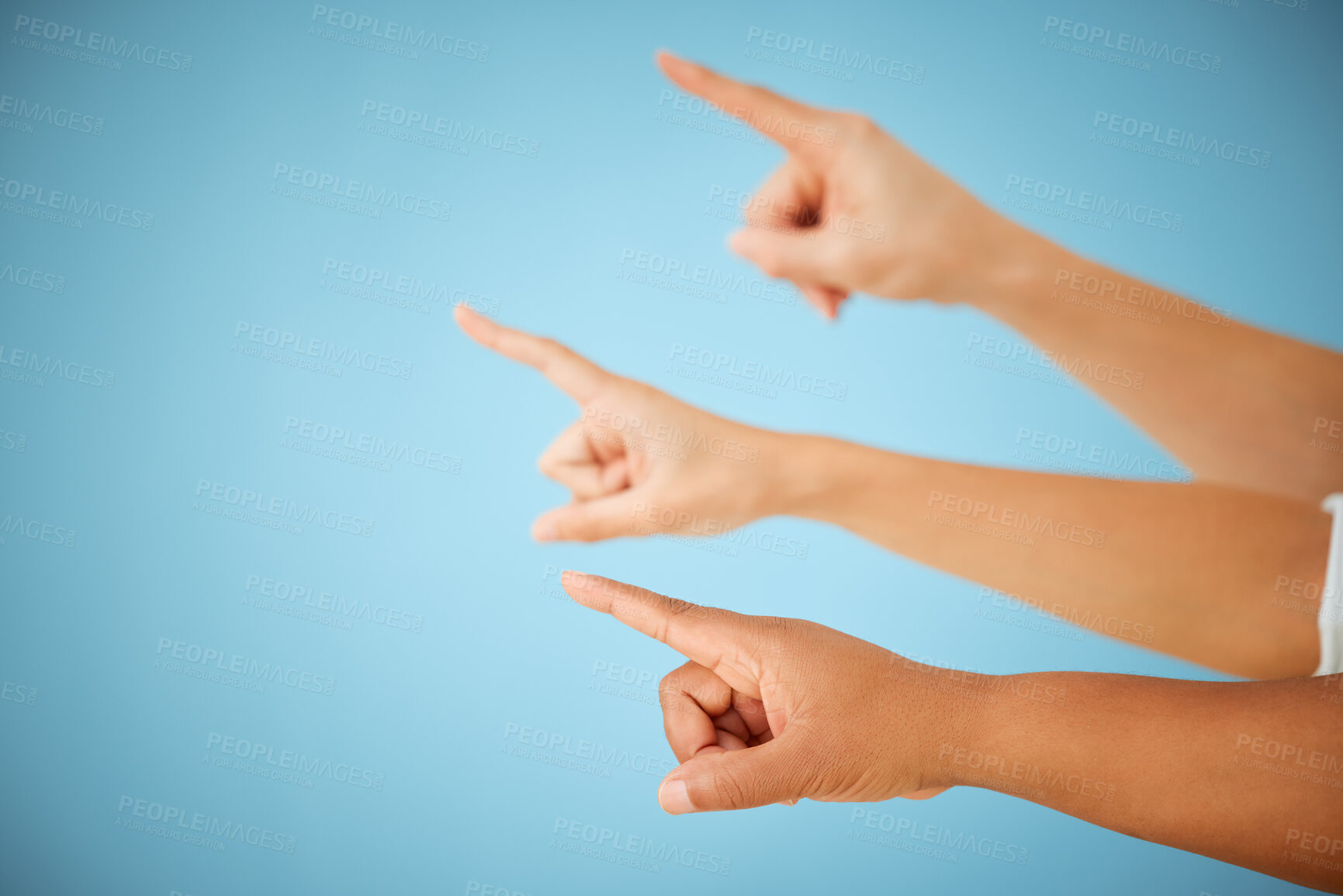 Buy stock photo Group, pointing and hands in studio, direction and forward in space, together and union for dismissal. Blue background, sign and people with gesture in mockup, fingers and showing of way to go