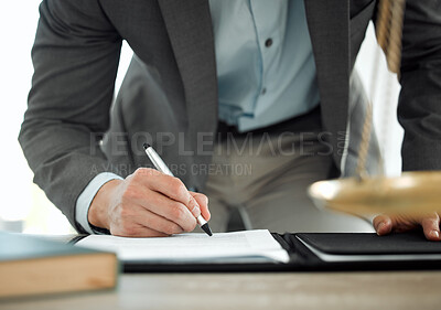 Buy stock photo Shot of a lawyer signing a contract in his office