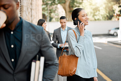 Buy stock photo Shot of a businesswoman making a phone call while walking to work with her colleagues