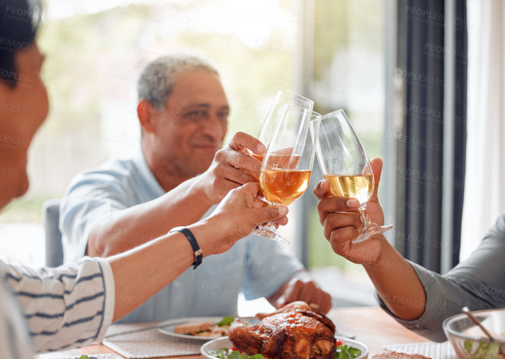 Buy stock photo Hands, family and cheers with champagne at house for thanksgiving, holiday celebration and lunch meal. Smile, people and toast with wine for dinner event, gratitude and social brunch of success party