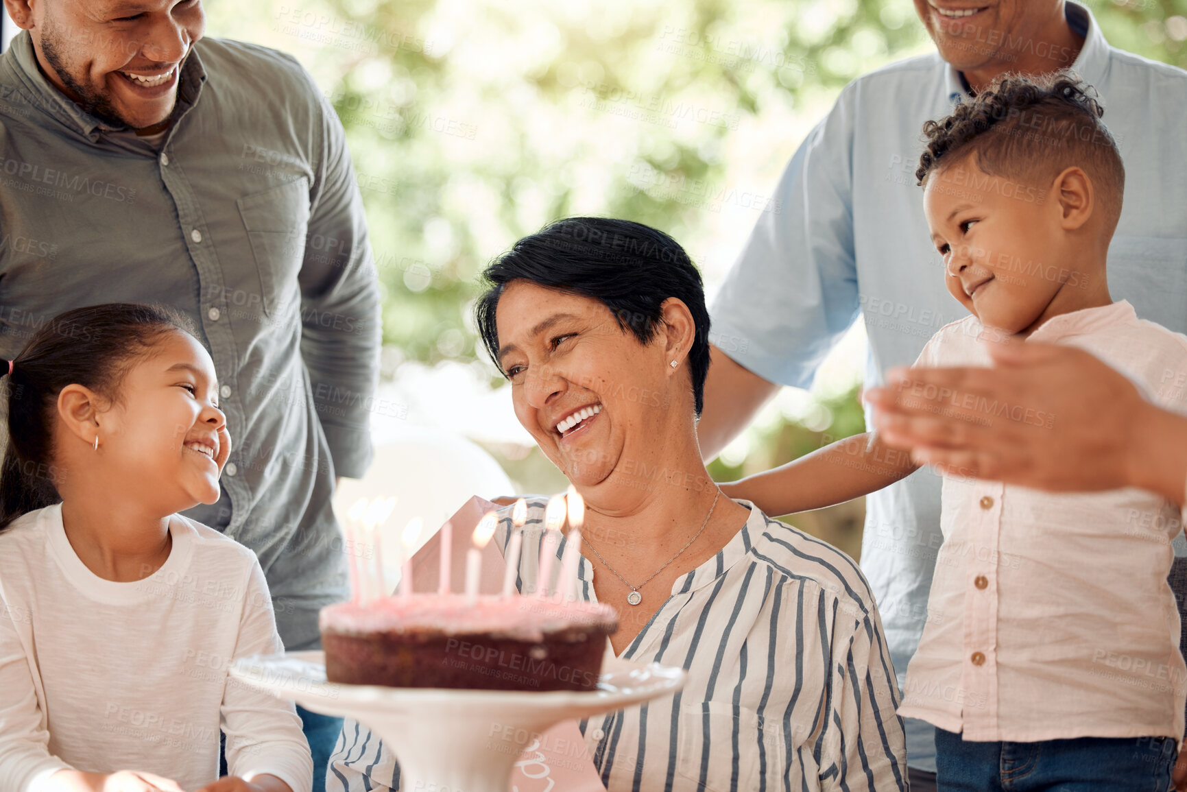 Buy stock photo Shot of a mature woman celebrating her birthday with family at home