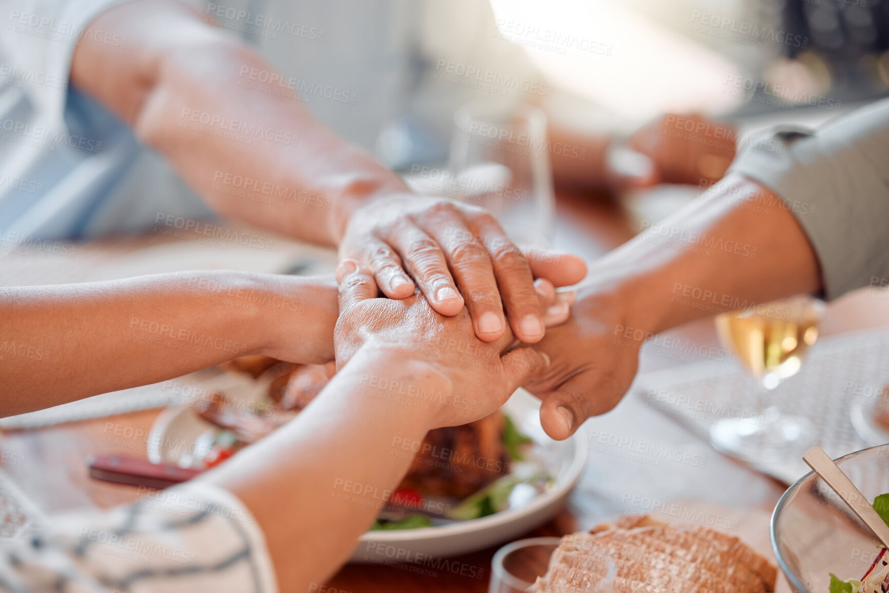 Buy stock photo Hands, huddle and prayer for dinner with family at table in home together for thanksgiving meal. Food, party and praying with group of people in dining room of apartment for bonding or festive feast