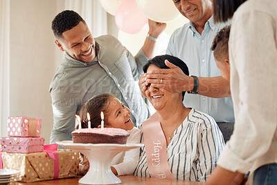 Buy stock photo Shot of a family surprising their mother with a birthday cake at home
