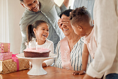 Buy stock photo Shot of a family surprising their mother with a birthday cake at home