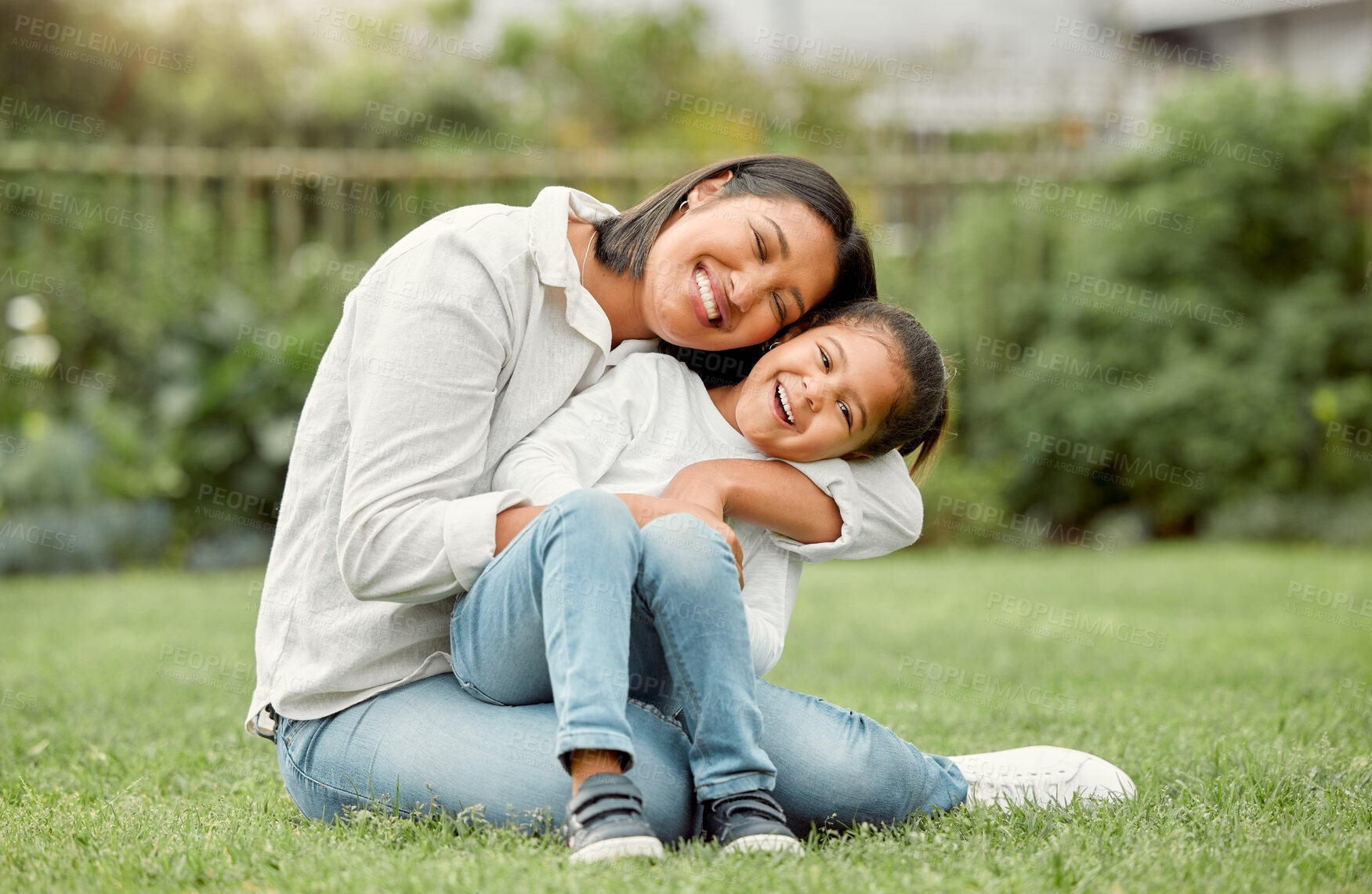 Buy stock photo Shot of an adorable little girl embracing her mother at the park